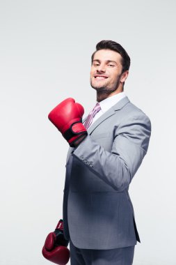 Smiling businessman in boxing gloves clipart
