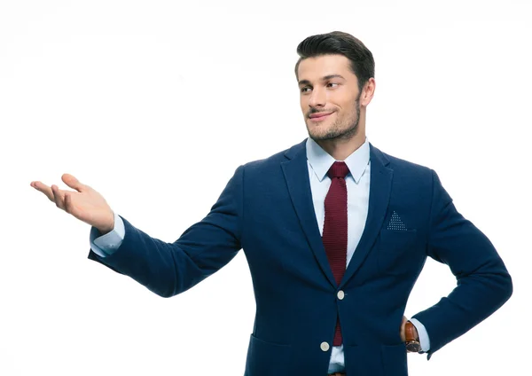 Happy businessman pointing away — Stock Photo, Image