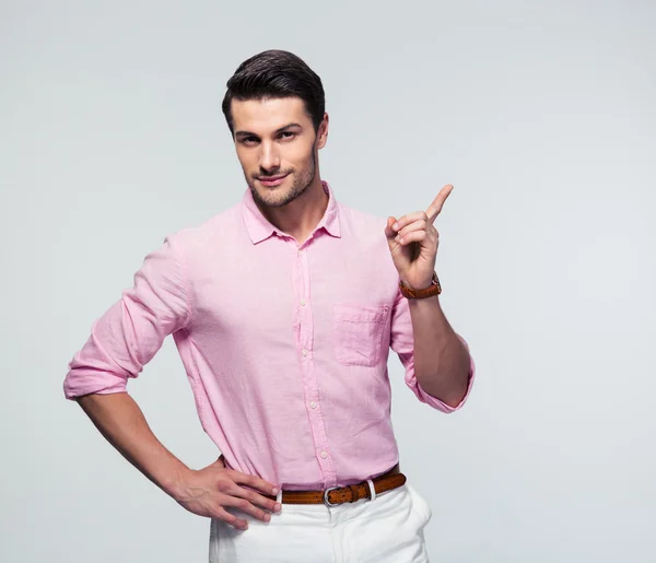 Confident businessman pointing finger away — Stock Photo, Image