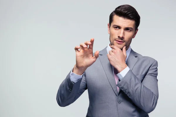 Pensive businessman touching a blank invisible screen — Stock Photo, Image