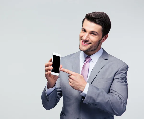 Businessman pointing finger on smartphone screen — Stock Photo, Image