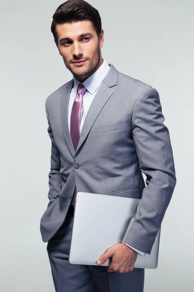 Businessman standing with laptop — Stock Photo, Image