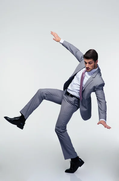 Businessman flying over gray background — Stock Photo, Image