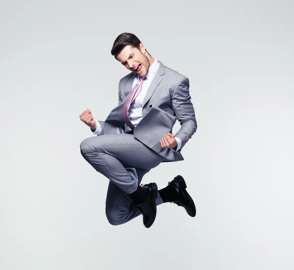 Funny businessman jumping in air — Stock Photo, Image