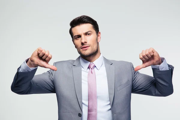 Handsome businessman pointing at herself — Stock Photo, Image