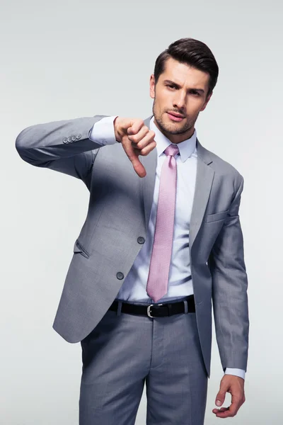 Businessman showing thumb down sign — Stock Photo, Image