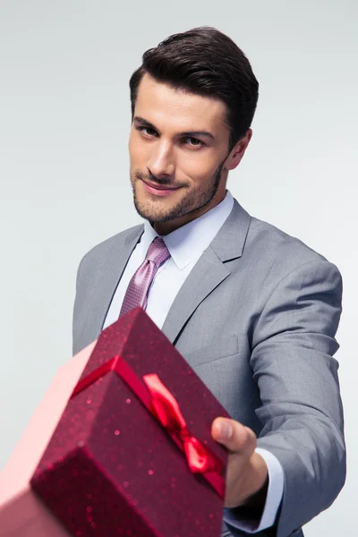 Businessman giving gift box