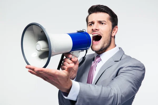 Businessman screaming in megaphone — Stock Photo, Image