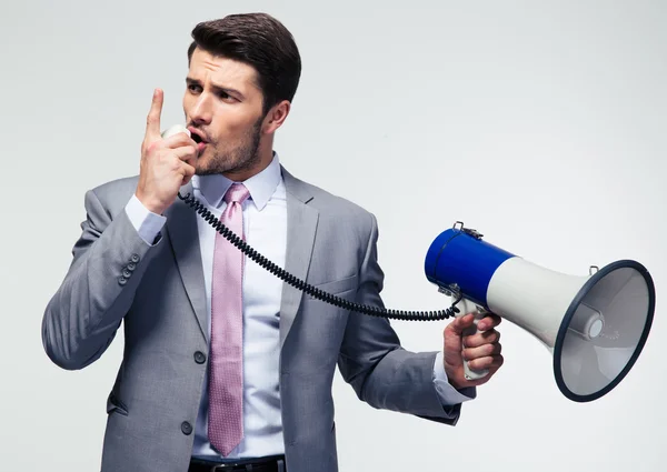 Businessman shouting in megaphone — Stock Photo, Image