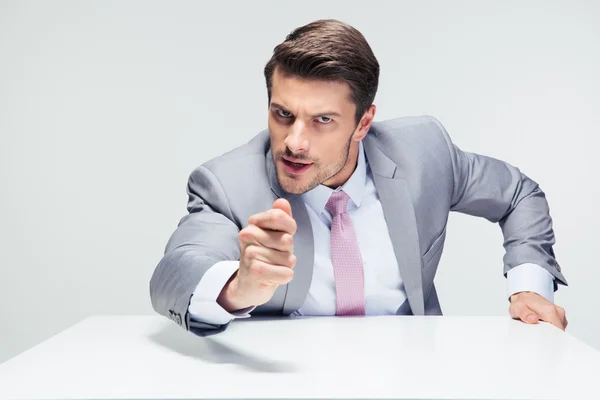 Angry businessman sitting at the table — Stock Photo, Image