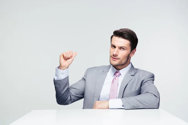 Confident businessman pointing finger back — Stock Photo, Image