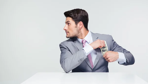 Empresario poniendo dinero en el bolsillo —  Fotos de Stock