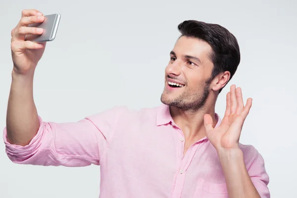 Happy businessman showing greeting sign on smartphone — Stock Photo, Image