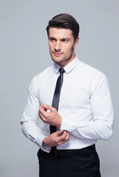Handsome businessman buttoning shirt — Stock Photo, Image