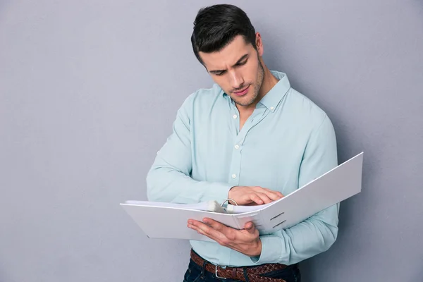 Handsome young man reading documents — Stock Photo, Image