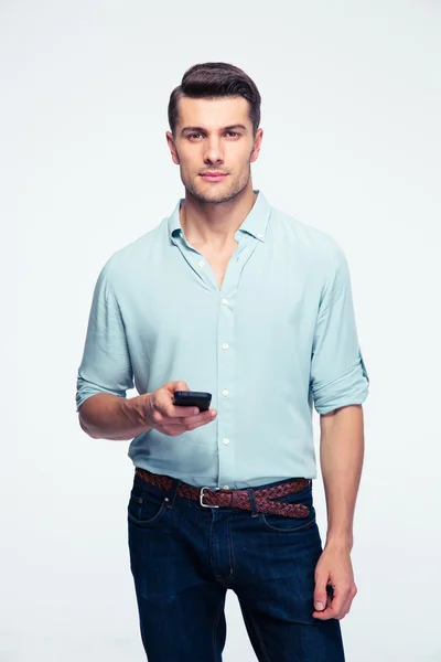 Handsome young man standing with smartphone — Stock Photo, Image