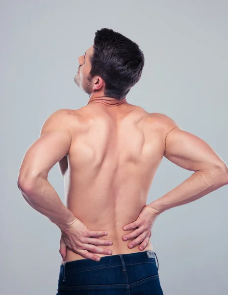 Muscular man having pain in back — Stock Photo, Image