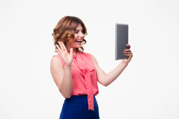 Woman making greeting gesture to tablet computer — Stock Photo, Image