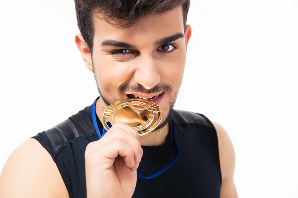 Sports man biting medal — Stock Photo, Image