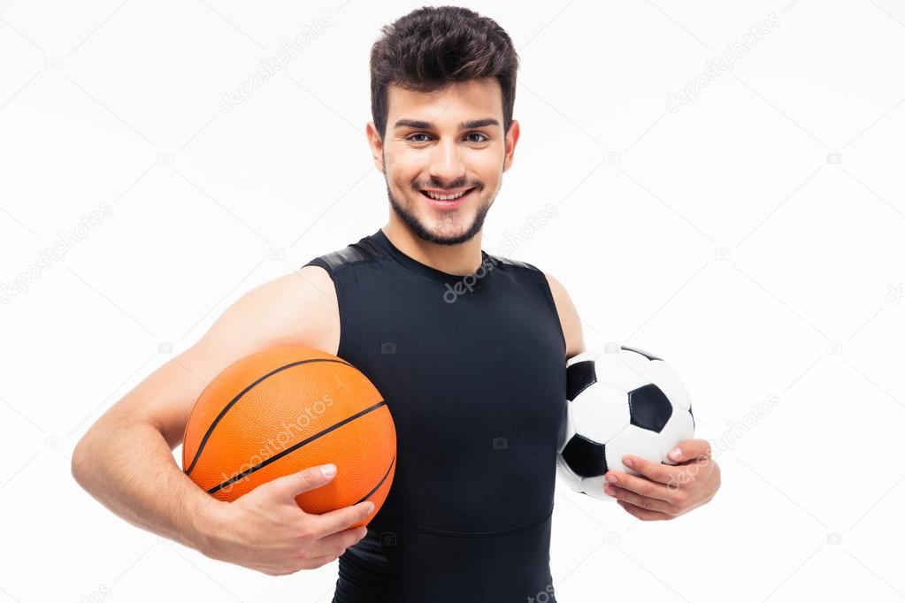 Sports man holding basketball and soccer ball