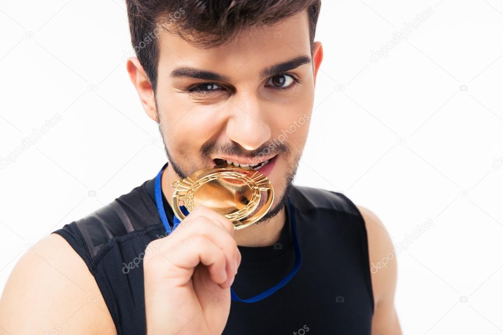 Sports man biting medal