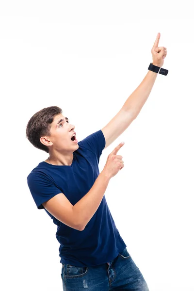 Shocked young man pointing finger up — Stock Photo, Image