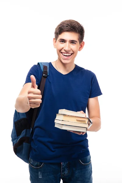 Estudante masculino segurando livro e mostrando polegar para cima — Fotografia de Stock