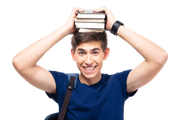 Sonriente estudiante masculino sosteniendo libros en la cabeza — Foto de Stock