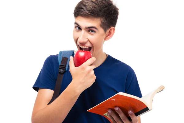 Estudiante masculino mordiendo manzana y leyendo libro —  Fotos de Stock