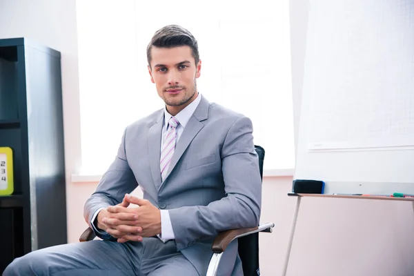 Hombre de negocios guapo sentado en la silla de la oficina —  Fotos de Stock
