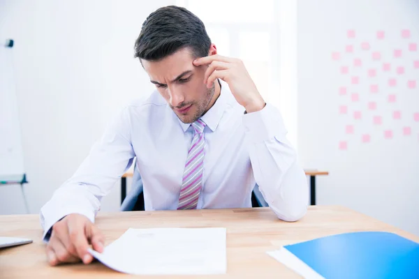 Handsome businessman reading document — Stock Photo, Image