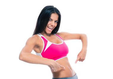 Sporty woman showing fingers at her belly
