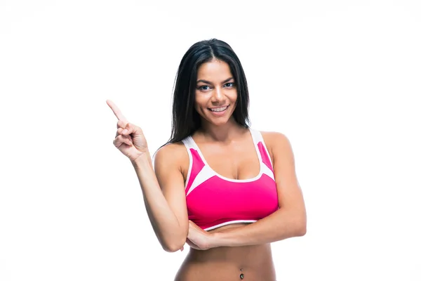 Smiling fitness woman pointing finger up — Zdjęcie stockowe