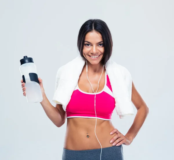 Smiling fitness woman holding bottle with water — Stock Photo, Image