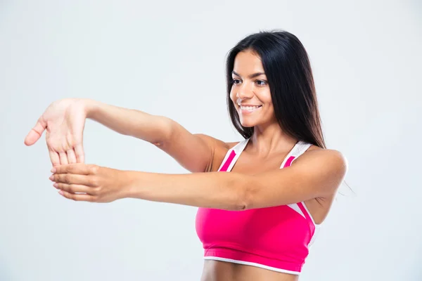 Sonriente mujer deportiva estirando los dedos —  Fotos de Stock