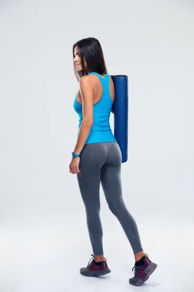 Back view portrait of a woman with yoga mat — Stock Photo, Image