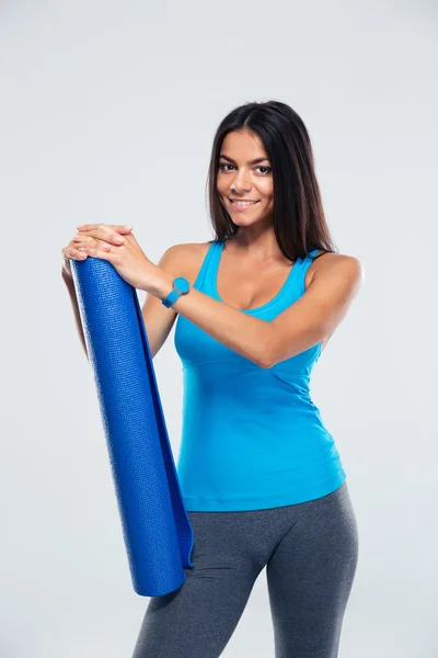 Happy sports woman holding yoga mat — Stock Photo, Image