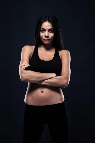 Fitness woman standing with hands crossed — Stockfoto