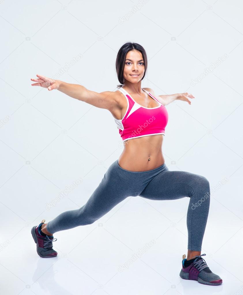 Full length portrait of a fitness woman stretching 