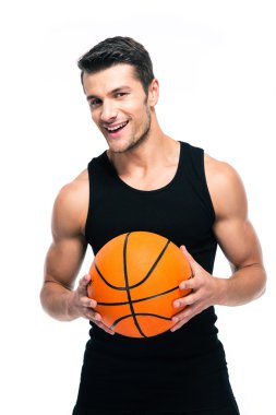 Cheerful basketball player standing with ball