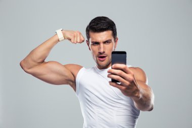 Sports man making selfie photo on smartphone 
