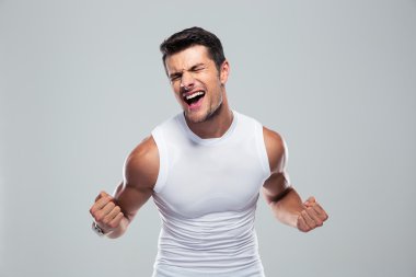 Muscular man celebrating his success