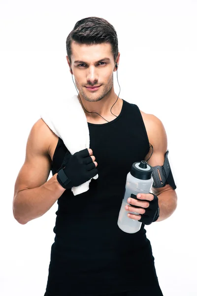 Handsome fitness man holding towel and bottle with water — Stockfoto