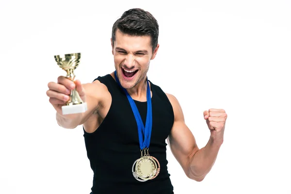Cheerful sports man holding winner cup — 图库照片