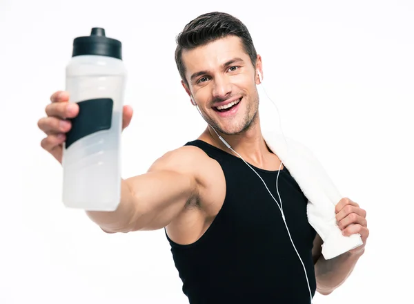 Smiling fitness man holding towel and bottle with water — Stock Photo, Image