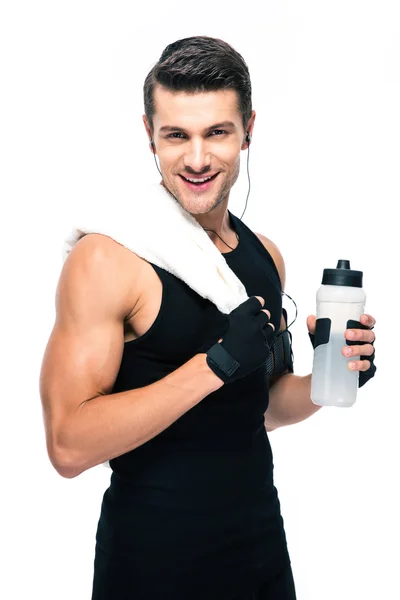 Happy sports man holding towel and bottle with water — Stok fotoğraf