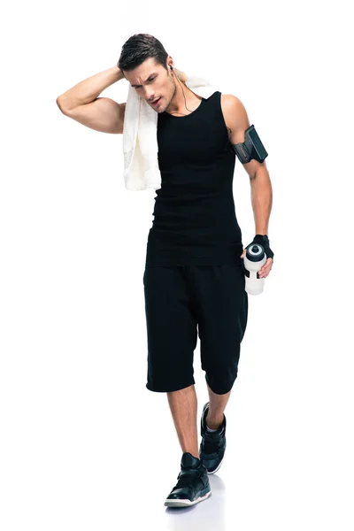 Fitness man holding towel and bottle with water — Stock Photo, Image