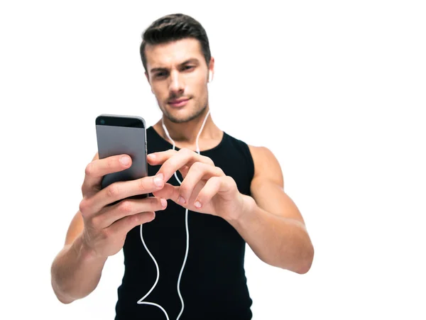 Sports man using smartphone with headphones — Stock fotografie