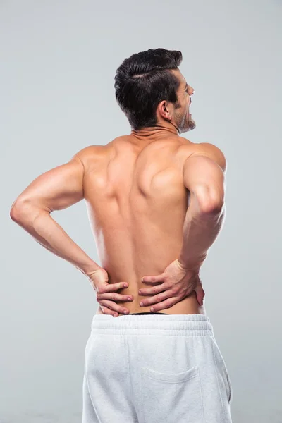 Portrait of a man standing with back pain — Stockfoto