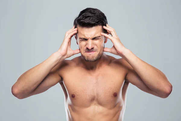 Naked man having headache — Stok fotoğraf